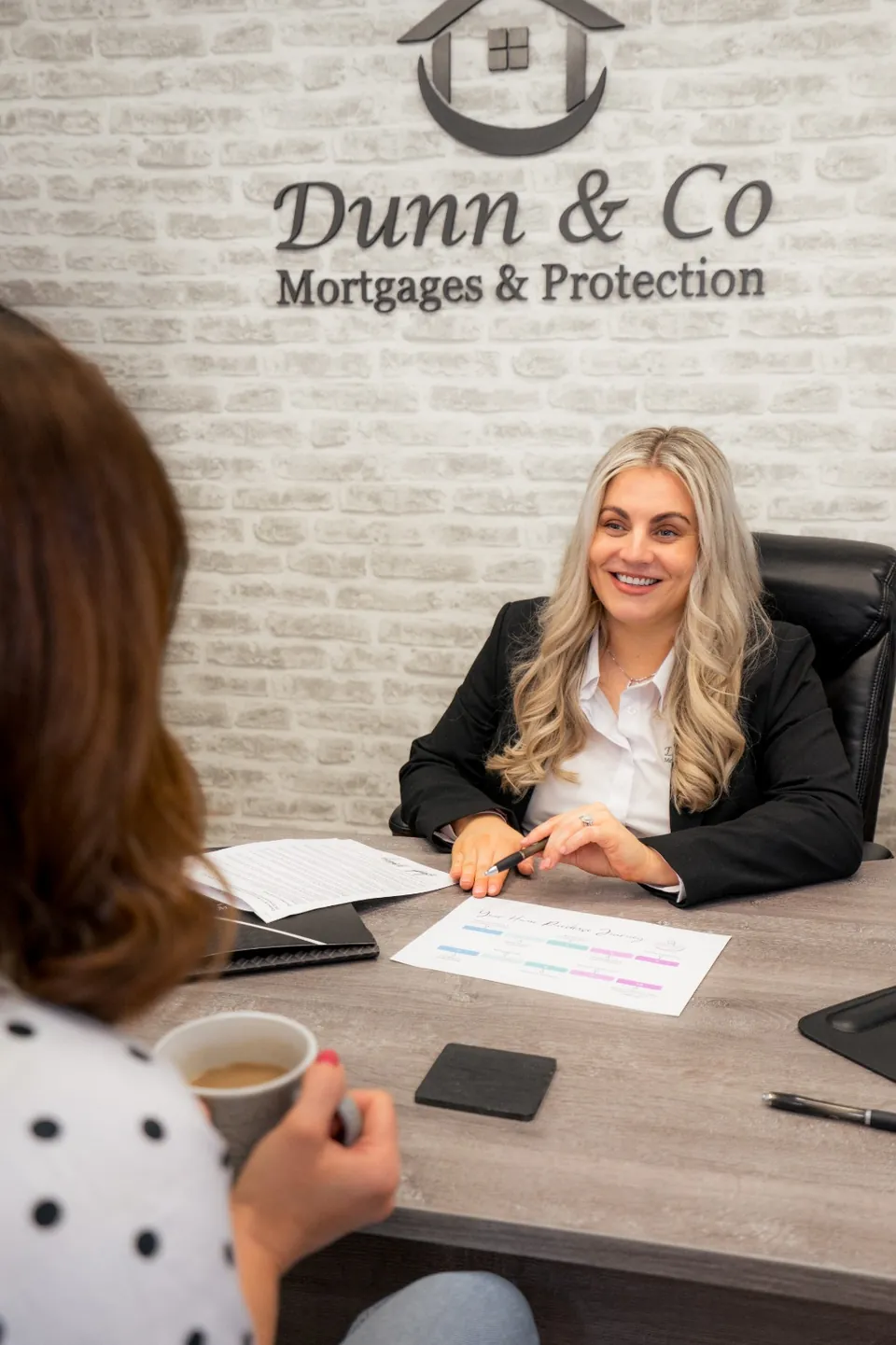 Eleanora discussing mortgage options with a client at the Dunn & Co Rathfriland office.