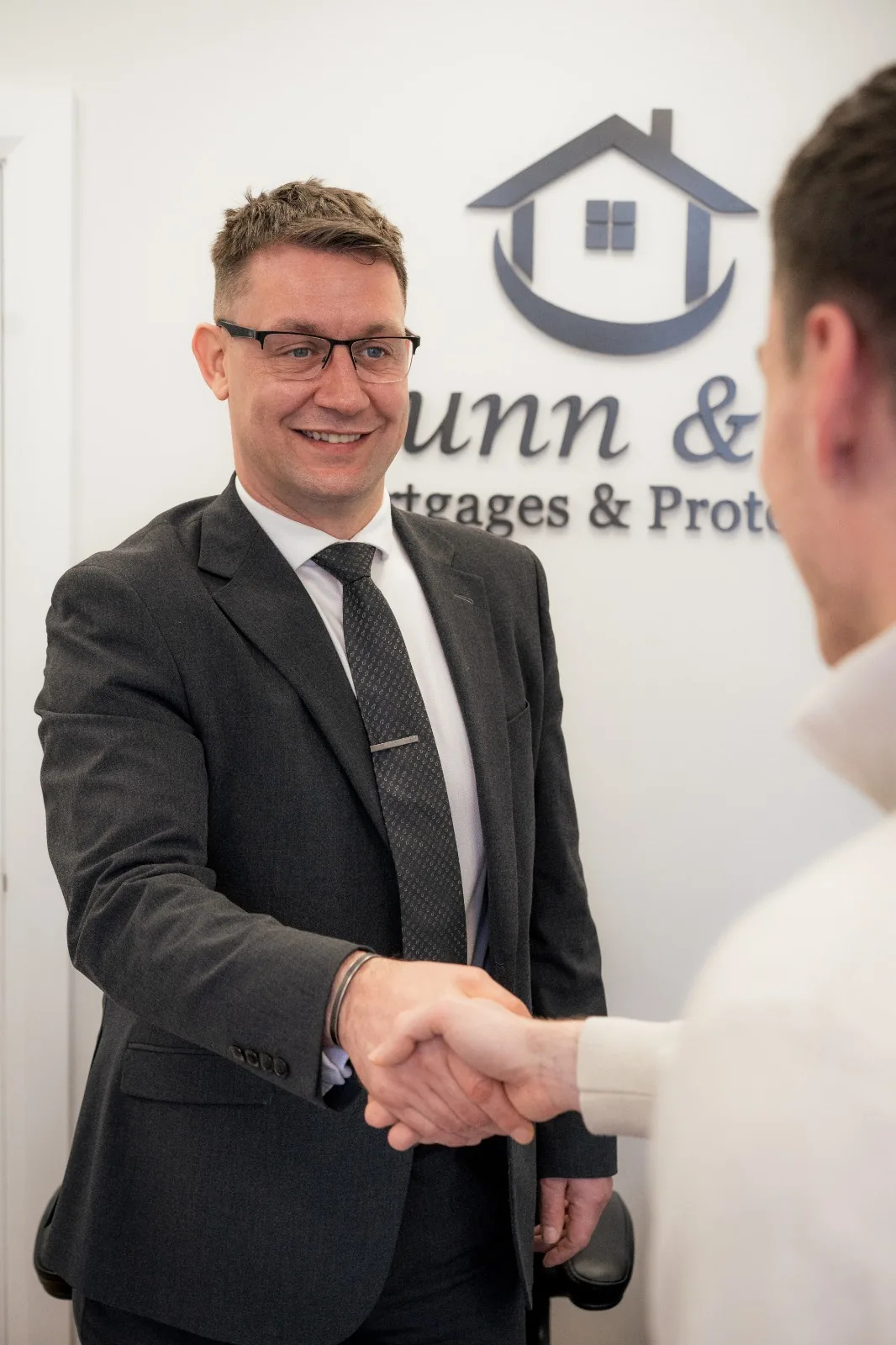Neil Dunn greeting a visitor at the Dunn & Co office.
